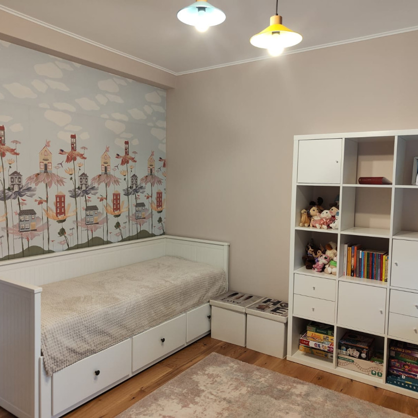 Tapet cu design floral cu case mici, pe un fundal albastru cu nori