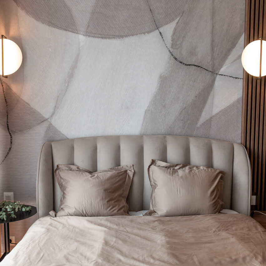 Tapet modern cu design minimalist, Asana, Sand, cu o pat în cameră, un perete gri cu modele abstracte, o oglindă pe un perete și un ghiveci cu ananas lângă fereastră