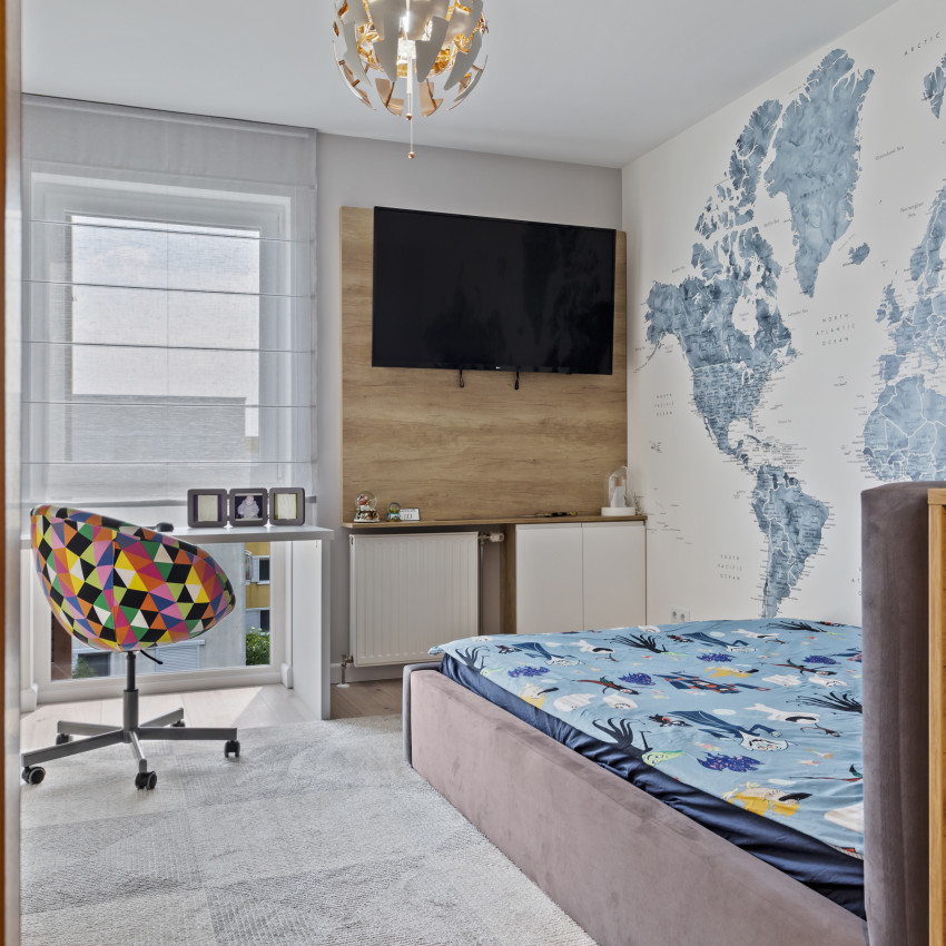 Harta lumii cu orașe în culori albastre și gri, printată pe tapet, în decorul unui living modern.