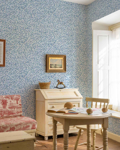 Tapet cu model delicat de frunze albastre pe fundal alb, intr-o camera decorata in stil rustic.