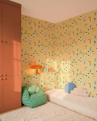 Tapet galben cu model floral colorat, înfățișând flori stilizate, picături de ploaie și elemente geometrice, într-o cameră amenajată pentru copii.
