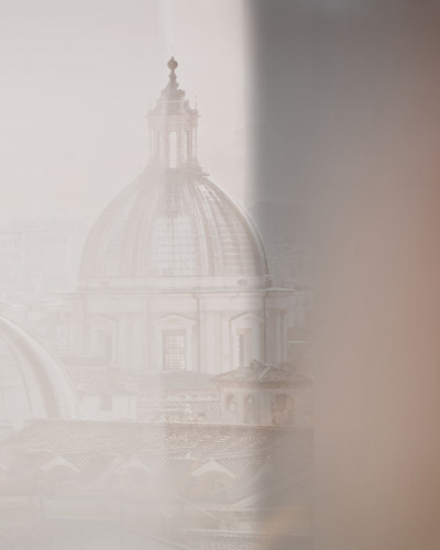 Tapet cu o imagine cu o cupola a unei biserici vazuta printr-o fereastra. Imaginea este redata in culori pastelate, cu un efect de estompare, creand o atmosfera romantica si calma.