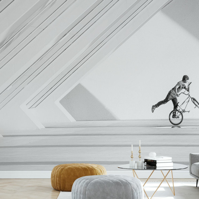 Fototapet cu un ciclist BMX realizând o manevră într-un spațiu modern, alb-negru