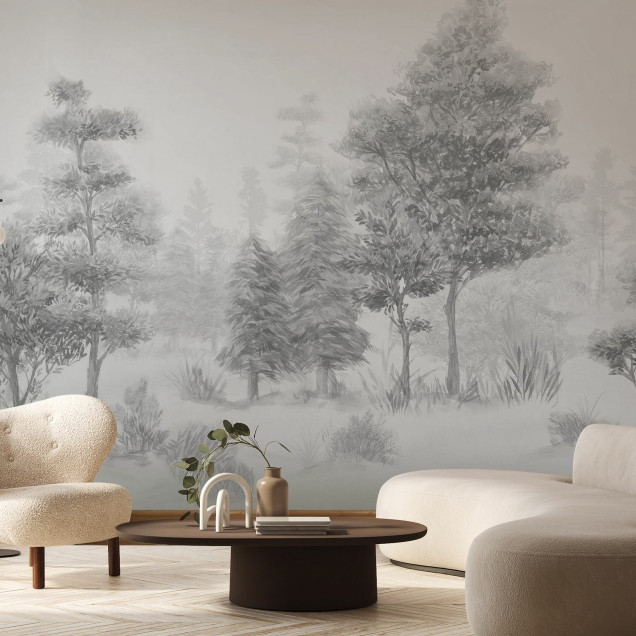 Tapet Bohemian Forest, BW, cu un design minimalist in tonuri de gri, cu o pădure liniștită, perfect pentru a crea o atmosferă relaxantă și sofisticată.  Se vede livingul cu canapea, scaun, masă de cafea și alte decorațiuni.