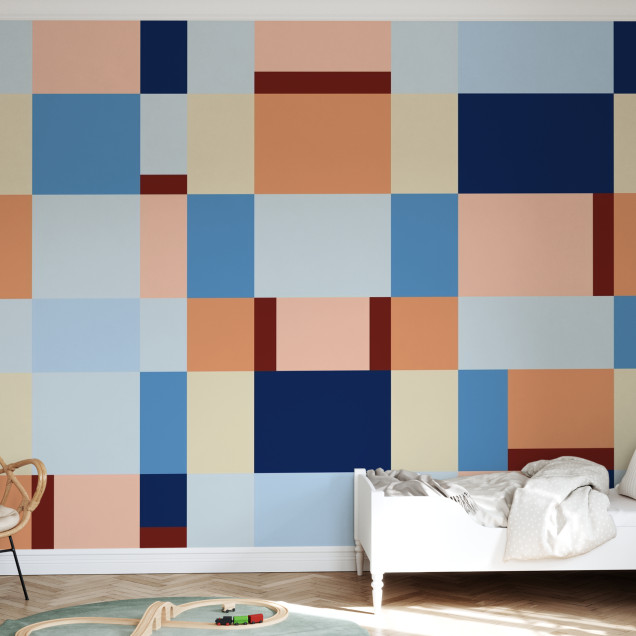 Fototapet cu design geometric în nuanțe de albastru și piersică în camera unui copil.