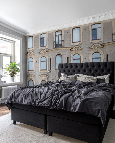 Tapet cu aspectul unei clădiri vechi, in stil minimalist. Imaginea prezintă un dormitor cu tapetul pe perete.