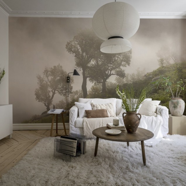 Un tapet cu un design realist al unui deal împădurit învăluit în ceață. Tapetul este aplicat pe un perete într-un dormitor, creând o atmosferă relaxantă și invitantă.