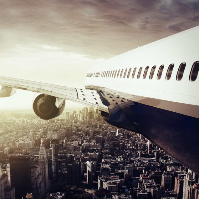 Tapet cu un avion care zboară deasupra unui oraș