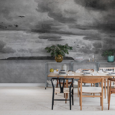 Seabirds Black & White wallpaper by Rebel Walls, featuring a hand-drawn landscape with birds flying, a cloudy sky and a coastline. The wallpaper is perfect for adding a touch of sophistication to any room.