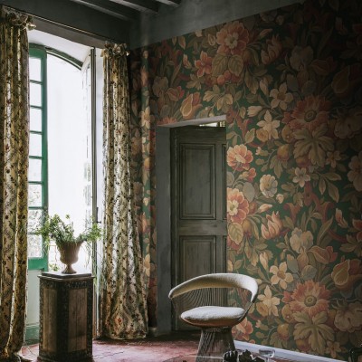 Tapet floral vintage în nuanțe de verde, cu flori mari și bogate, pe un perete într-o cameră cu mobilier vintage.