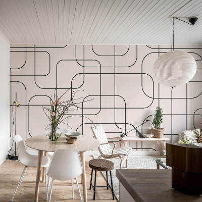 Wallpaper cu linii grafice negre pe fundal bej, in interiorul unei camere de zi moderne.