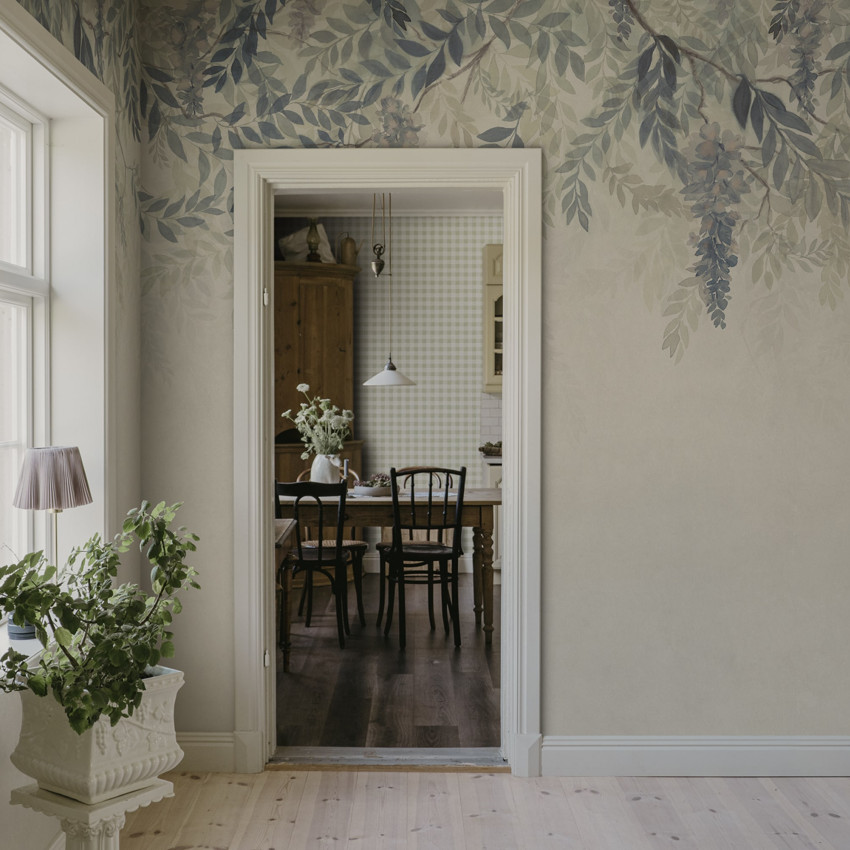 Tapet floral cu motiv de glicină verde și mov într-o cameră cu mobilier din lemn.