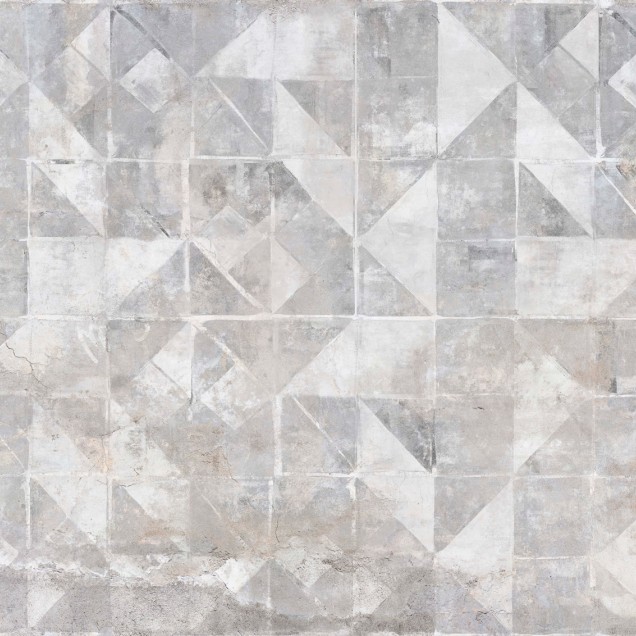 Tapet modern cu model geometric Tintagel, Grey, ilustrat pe un perete din living, lângă un fotoliu gri cu perne decorative.