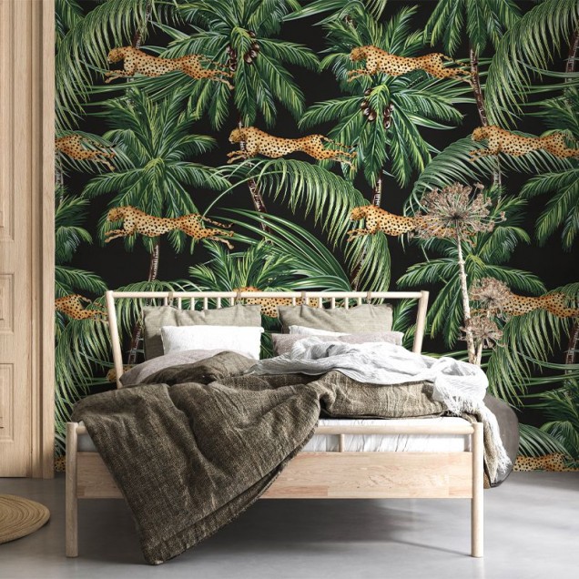 Jungle pattern wallpaper with cheetahs leaping through palm trees on a black background.