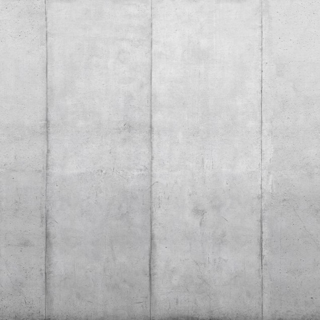 Tapet cu blocuri de beton, design modern și minimalist, cu o canapea gri în prim plan.