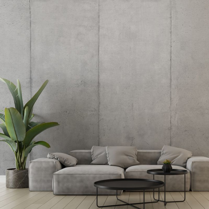 Tapet cu blocuri de beton, design modern și minimalist, cu o canapea gri în prim plan.
