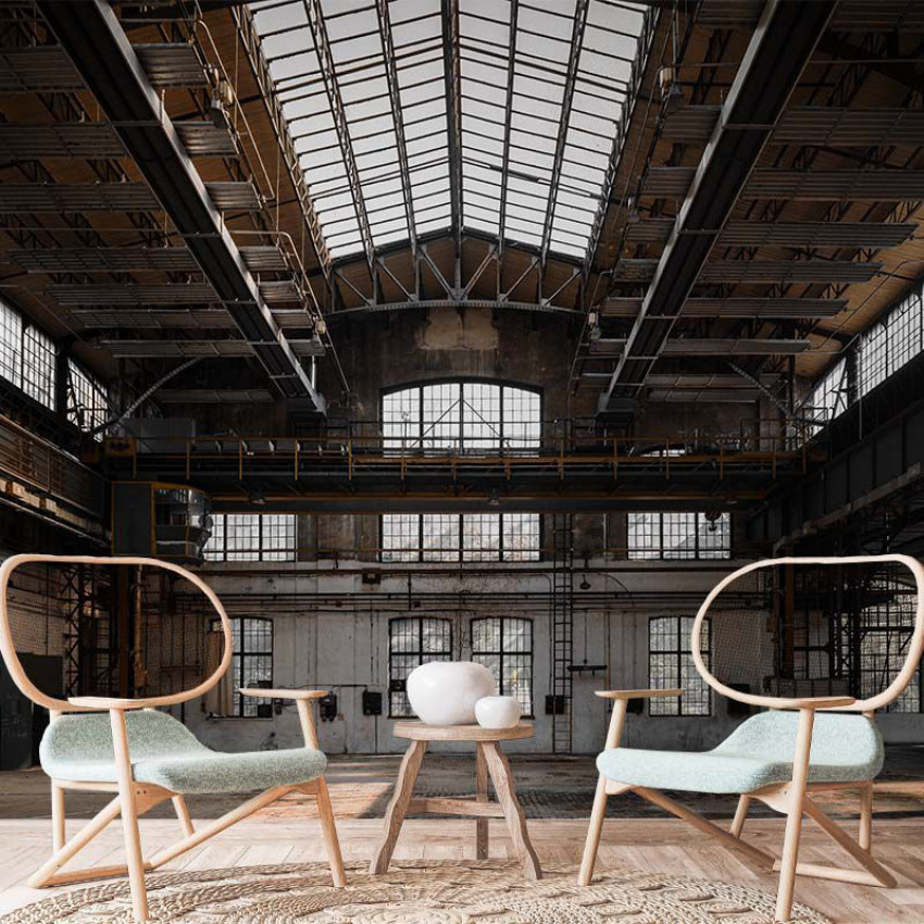 Tapet cu imagine a unei hale industriale vechi, cu structura din otel si ferestre mari.