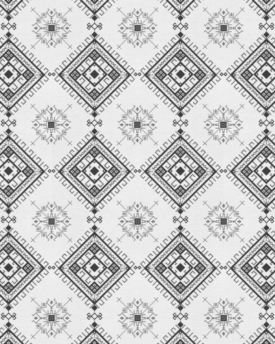 Tapet cu model geometric alb-negru pe un perete din living.