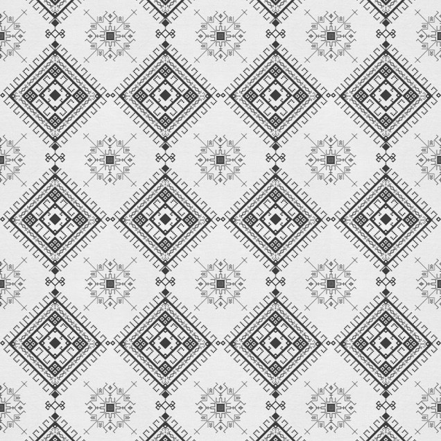 Tapet cu model geometric alb-negru pe un perete din living.